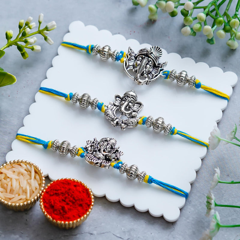 Lord Ganesha Rakhi Set of 3 – Antique Metal Finish – Free Chawal & Kumkum
